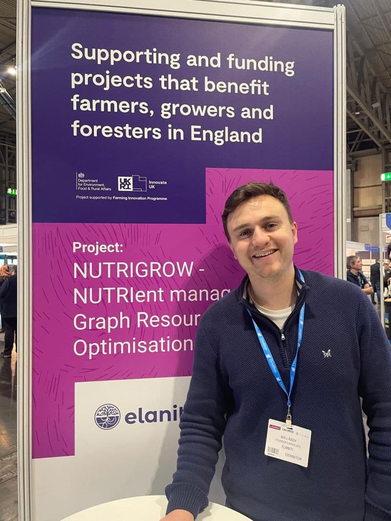Will Rady standing in front of our UKRI stand